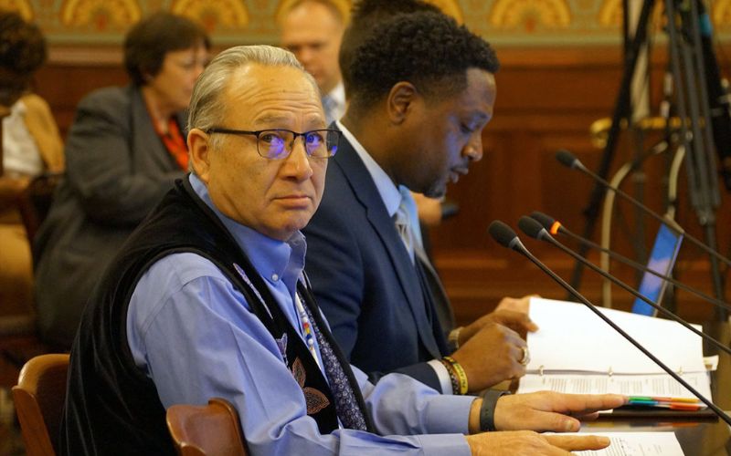 Joseph “Zeke” Rupnick, tribal chairman of the Prairie Band Potawatomi Nation, speaks at a committee hearing at the Illinois Capitol last year alongside state Rep. Maurice West, D-Rockford. West convenes a Native American working group to inform legislation at the Illinois Capitol. (Capitol News Illinois photo by Peter Hancock)