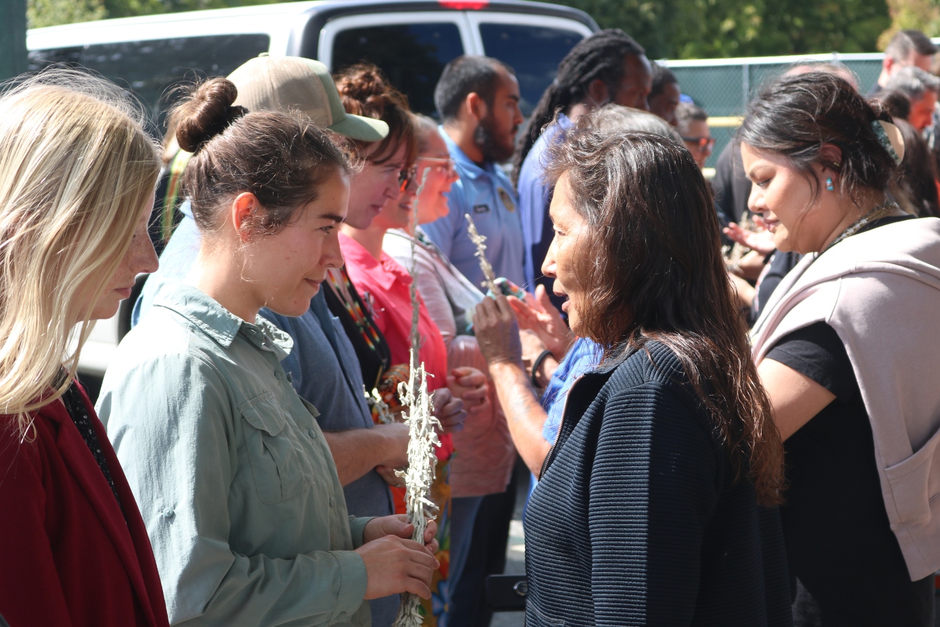 Michelle Wanna (right), a member of the LaFromboise family, explains to one of the archeologists the importance of traditional plant medicines and cultural ways. (Photo Jenna Kunze)