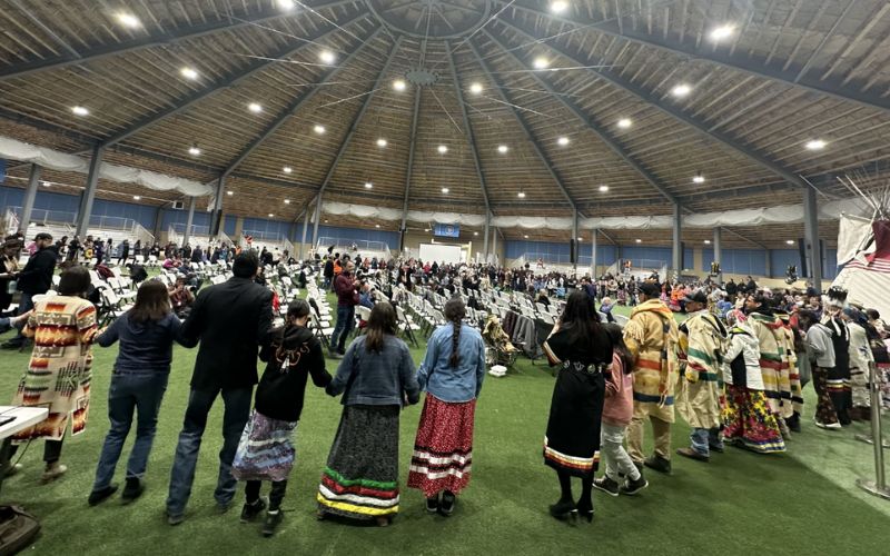 Attendees of the Lily Gladstone celebration form a circle for a round dance on Tuesday, March 26, 2024. Credit: JoVonne Wagner / MTFP