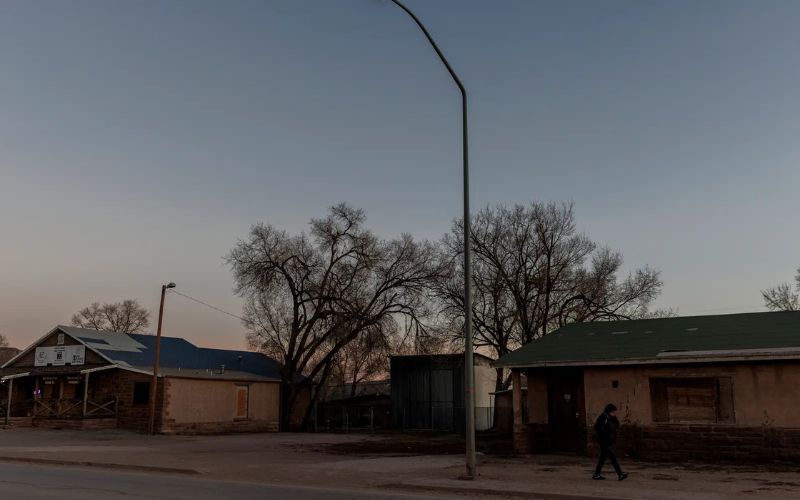 A person walks past the location where, according to Anders Hustito, white vans stopped to collect people and bring them to sober homes in Arizona. (photo/Adriana Zehbrauskas, special to ProPublica)