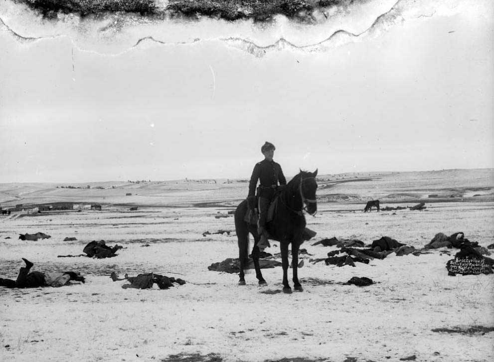 Lt. Sydney A. Cloman, who accompanied the burial party and drew the official map of the scene, sits on horseback among the scattered, frozen bodies of Lakota Sioux, including Chief Big Foot, throughout the Pine Ridge Indian Reservation. (Photo courtesy of Denver Public Library Special Collections.)