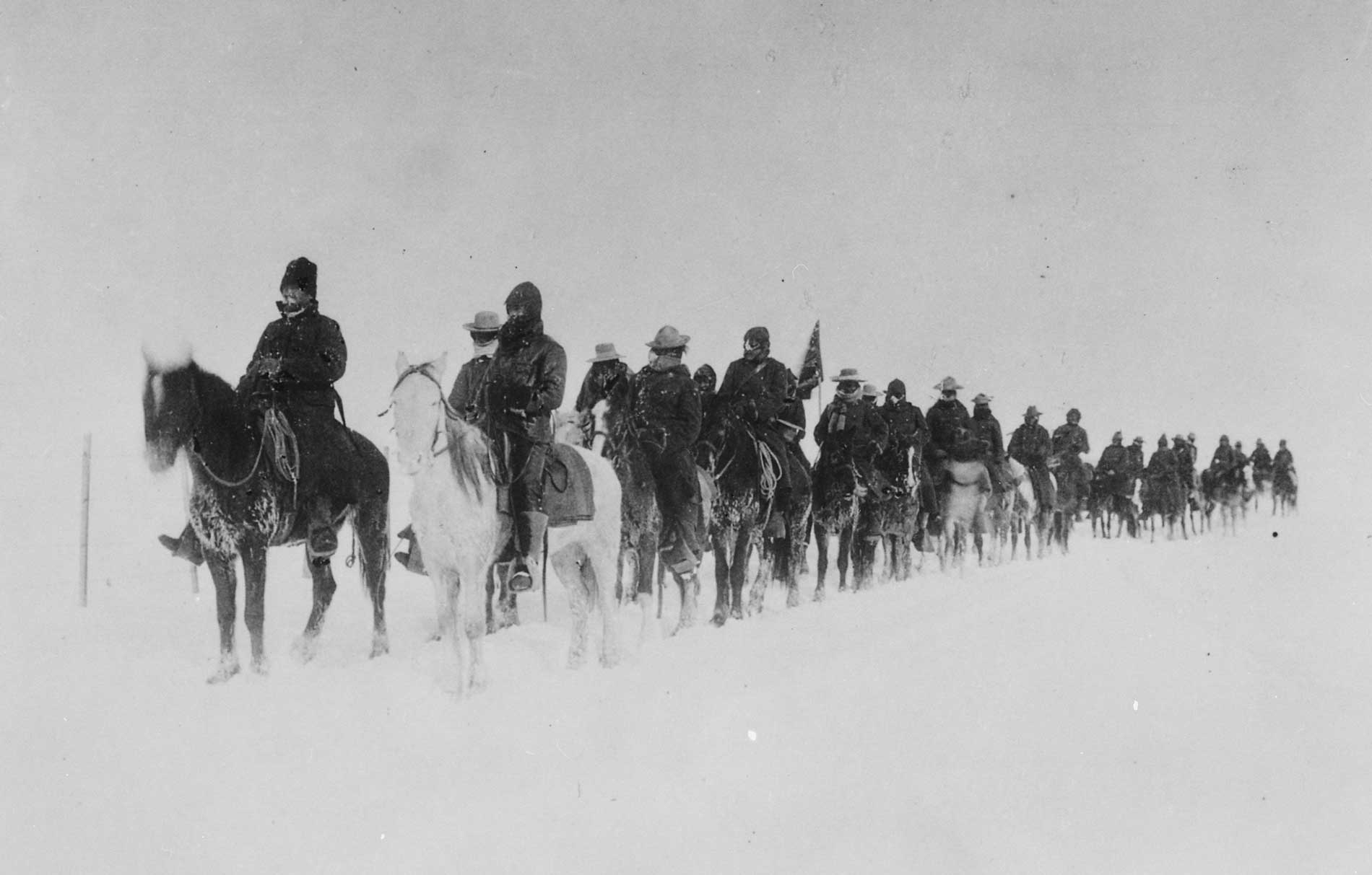 Lt. Edward W. Casey’s Cheyenne Army Scouts ride on horseback, returning from the Pine Ridge Indian Reservation during a blizzard. (Photo courtesy of the National Archives.)
