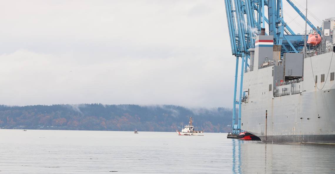 A small vessel carrying water warrior allies, left, floats near a Tacoma police boat and a U.S. Coast Guard boat that guard the MV Cape Orlando, a U.S. military ship , on Monday, Nov. 6, 2023. (Photo/Rosemary Montalvo Rosemary Montalvo for The News Tribune)  