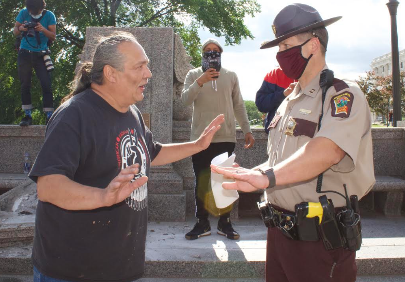 Mike Forcia talking with a Minnesota State Police officer