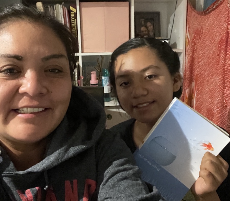 Audrina Romero (right), shown with her mother Misty, is one of 75 students who has new access to light and electrical power through a solar power station kit installed by the Heart of America and Young Living Foundations. (Photo/Misty Romero)
