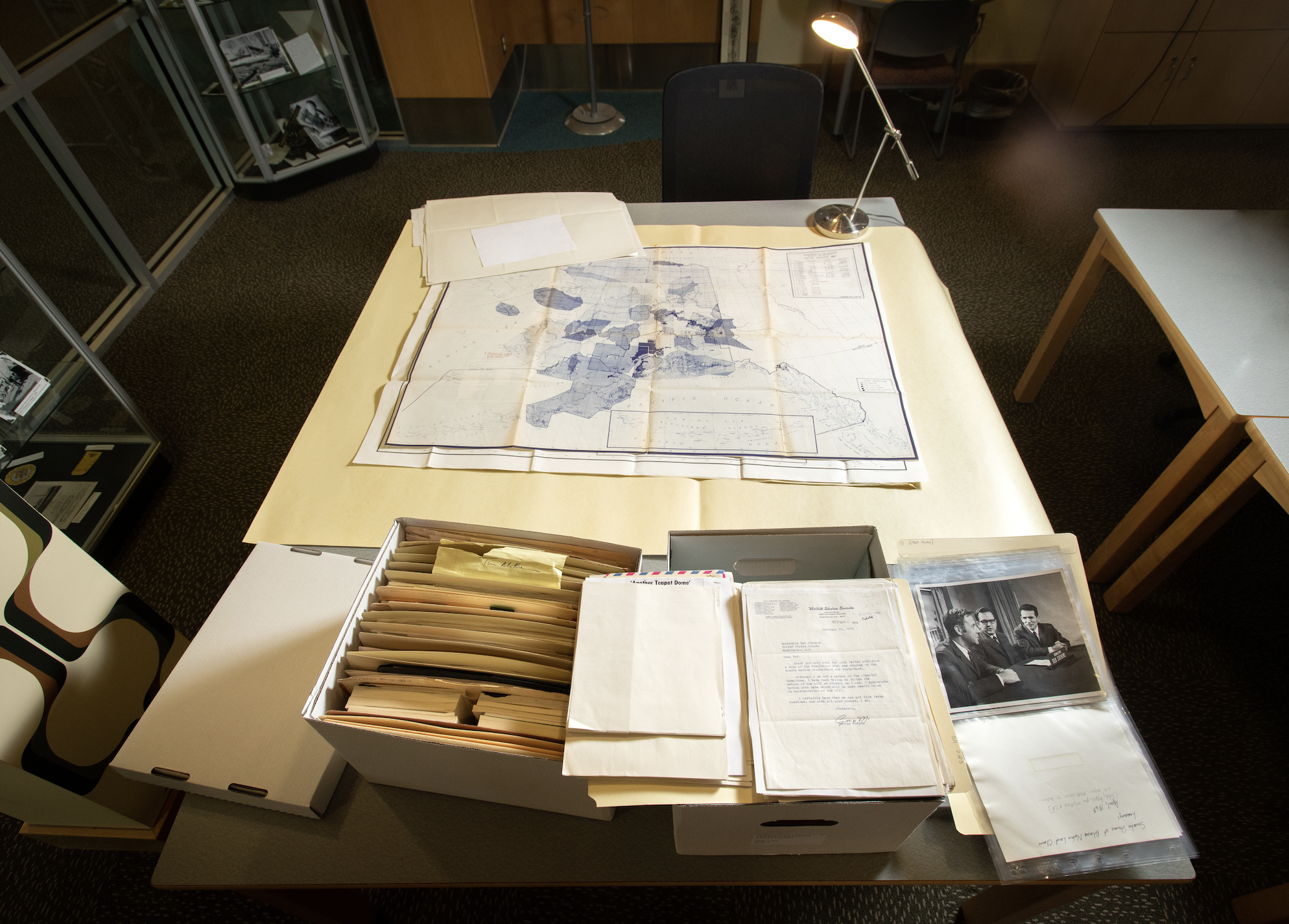 Documents, maps, and photo on table