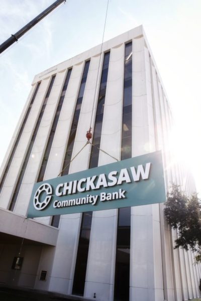 A crane hoists the new Chickasaw Community Bank sign to the top of the former Bank2 building, 909 South Meridian Ave., Oklahoma City, during a ribbon cutting and unveiling ceremony Jan. 14 to officially change the bank’s name to Chickasaw Community Bank. Photos courtesy of Chickasaw Media