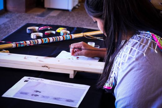 Courtney Parchcorn beads while working at the Chickasaw Cultural Center. Employed as a cultural specialist, Parchcorn spends her time educating and informing visitors at the cultural center.