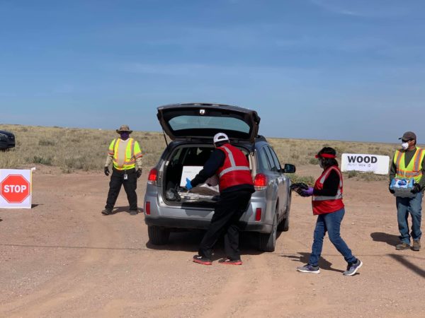 Navajo Nation President Jonathan Nez helps unload food to be distributed to families in need.