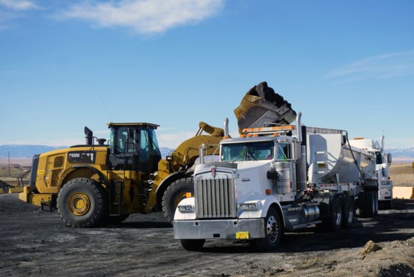A front-end loader loads coal to a tractor-trailer schedule to travel to a Navajo Chapter to receive free coal from NavajoMine as part of the Community Heating Resource Program
