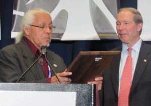Joe Garcia presents Sen. Tom Udall of New Mexico with a special recognition award on Tuesday afternoon. (Native News Online photo.)