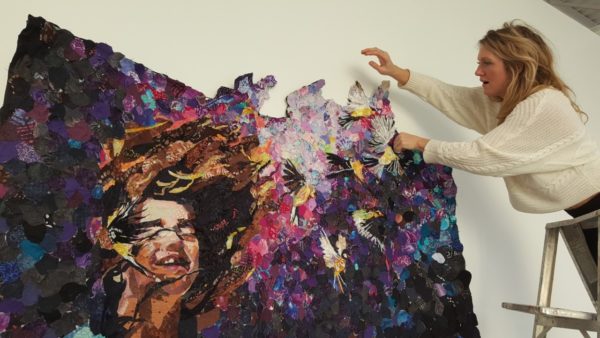 Blair Treuer installing "Portraits" at Watermark Art Center