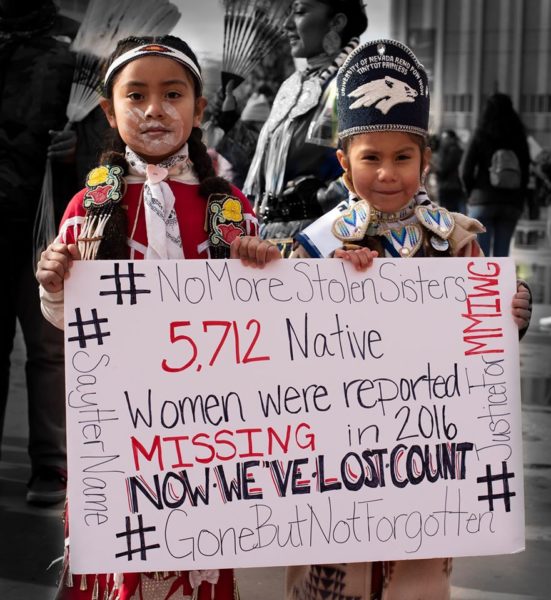 "I asked these two young ladies to hold up the sign so I could post it on FB and help shed some light on this terrible tragedy" -- Mark Sloane in Reno, Nevada