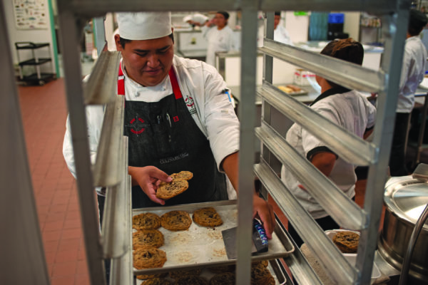 NTU Professional Baking graduate Shawn Curley removes a cookie sheet during class in 2016. NTU’s Professional Baking and Culinary Arts programs were granted re-accreditation for five years in November.