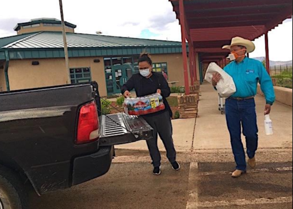 Navajo Nation Council Delegate Wilson Stewart Jr. loads food and supplies from Crystal Chapter House to deliver to the Hermes Family.