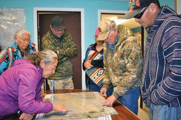 NAVAJO TIMES | RIMA KRISSTCoalmine Canyon Chapter members pore over a map to confirm where the proposed Navajo Power utility scale solar project will be located.