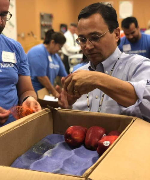 Cherokee Nation Principal Chief Chuck Hoskin Jr. volunteers alongside CNB employees at the food bank's Donald W. Reynolds Distribution Center.