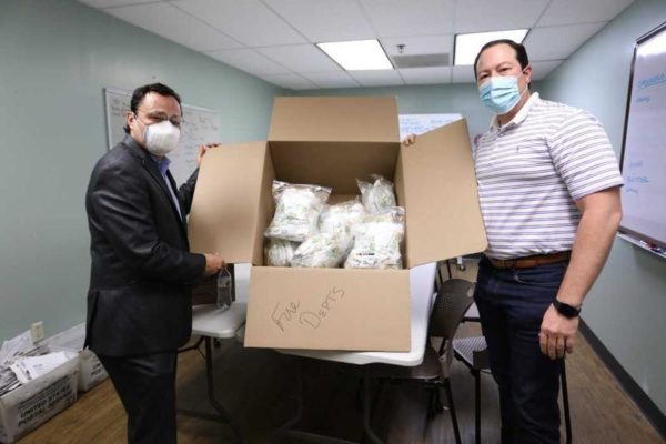 Cherokee Nation Principal Chief Chuck Hoskin Jr. (left) and Deputy Principal Chief Bryan Warner with some of the 7,500 masks donated both locally and to the Navajo Nation. - Courtesy Photograph